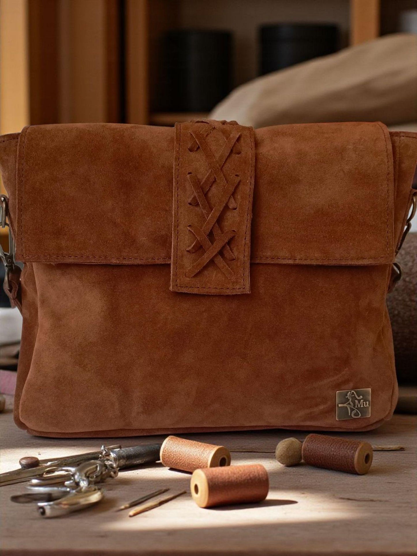 The product is a women's bag made of real suede leather.