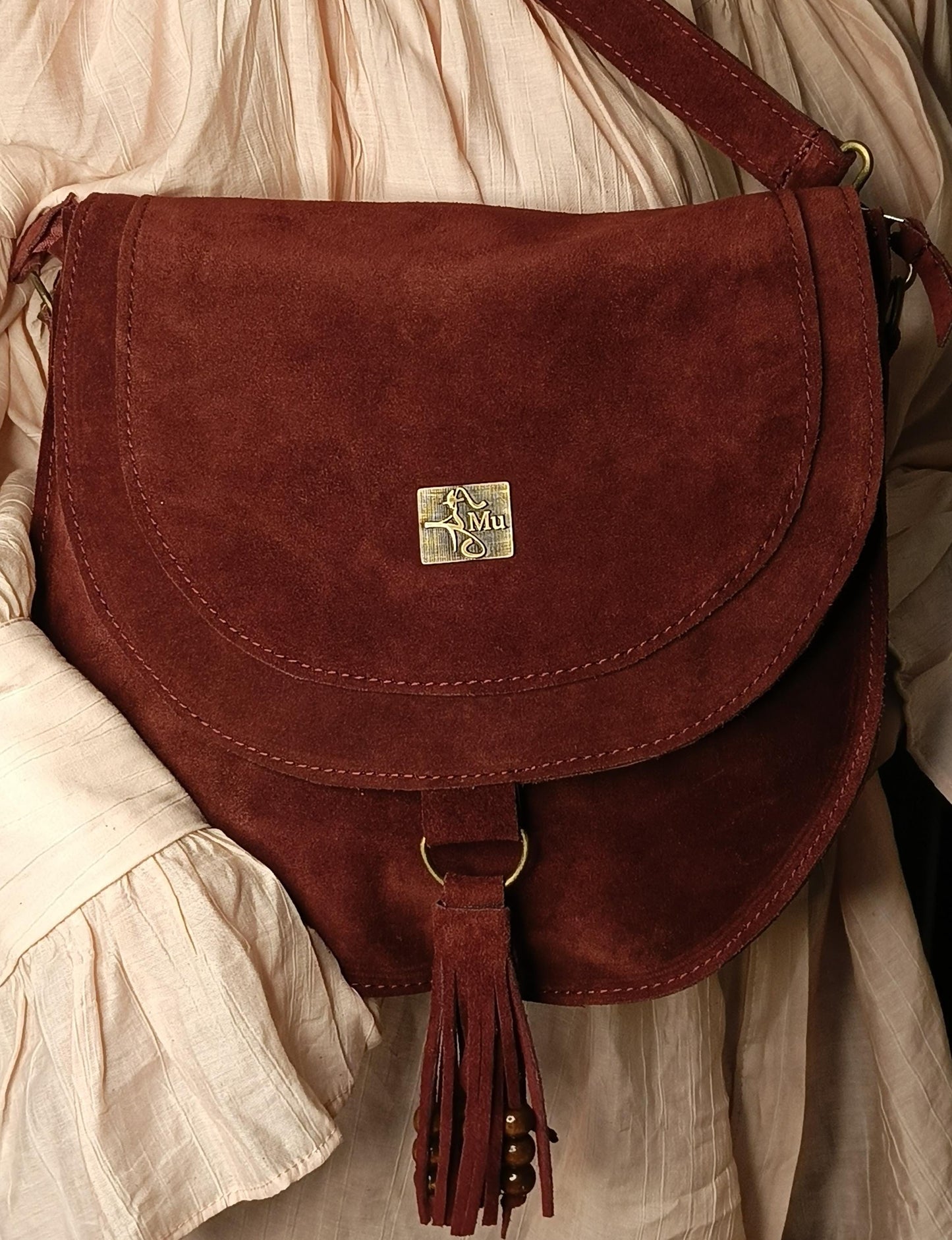 Made of real suede leather. It is a designer product.