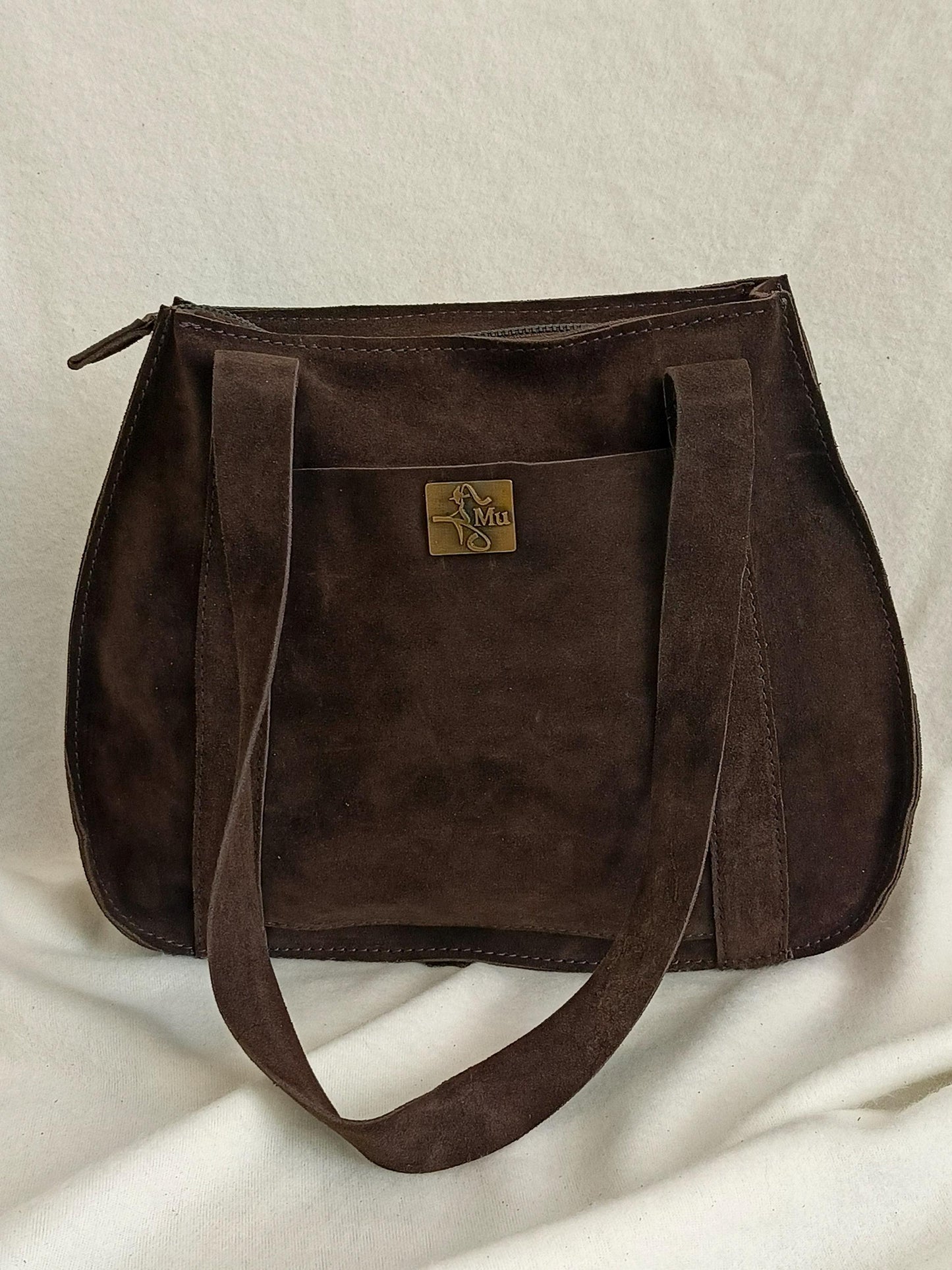 the product is made of genuine suede leather.design is a bag.suitable for daily use.