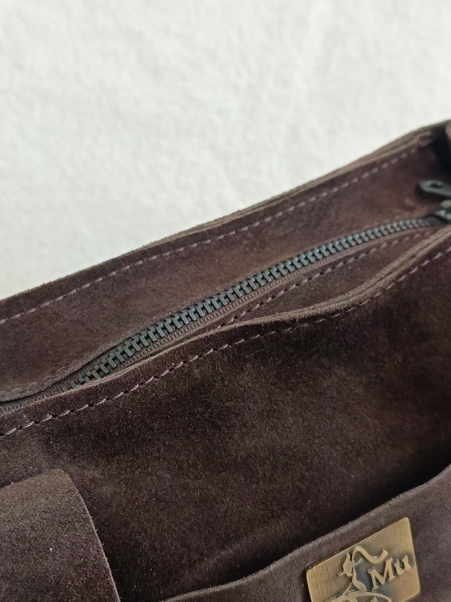 the product is made of genuine suede leather.design is a bag.suitable for daily use.