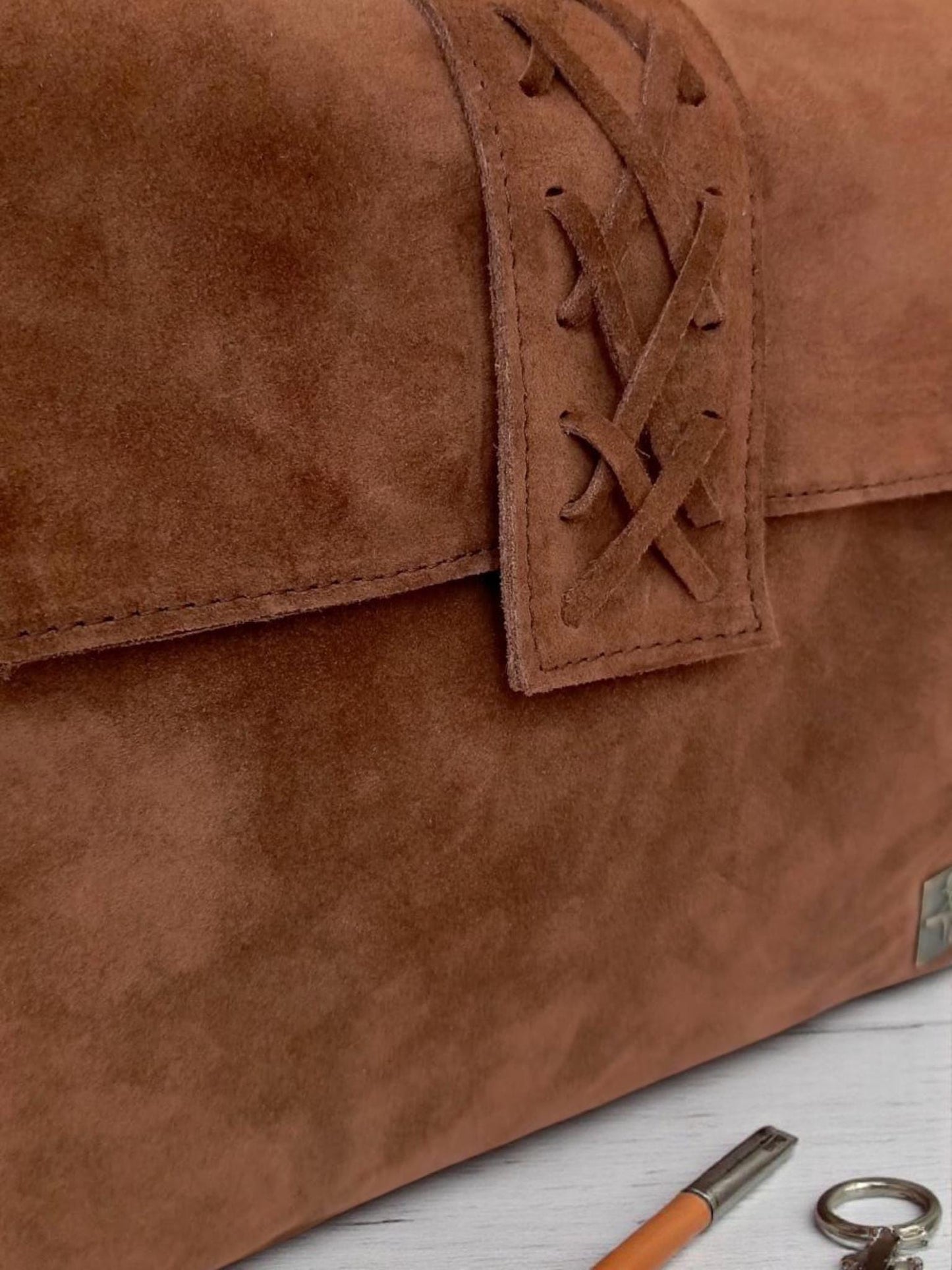 The product is a women's bag made of real suede leather.