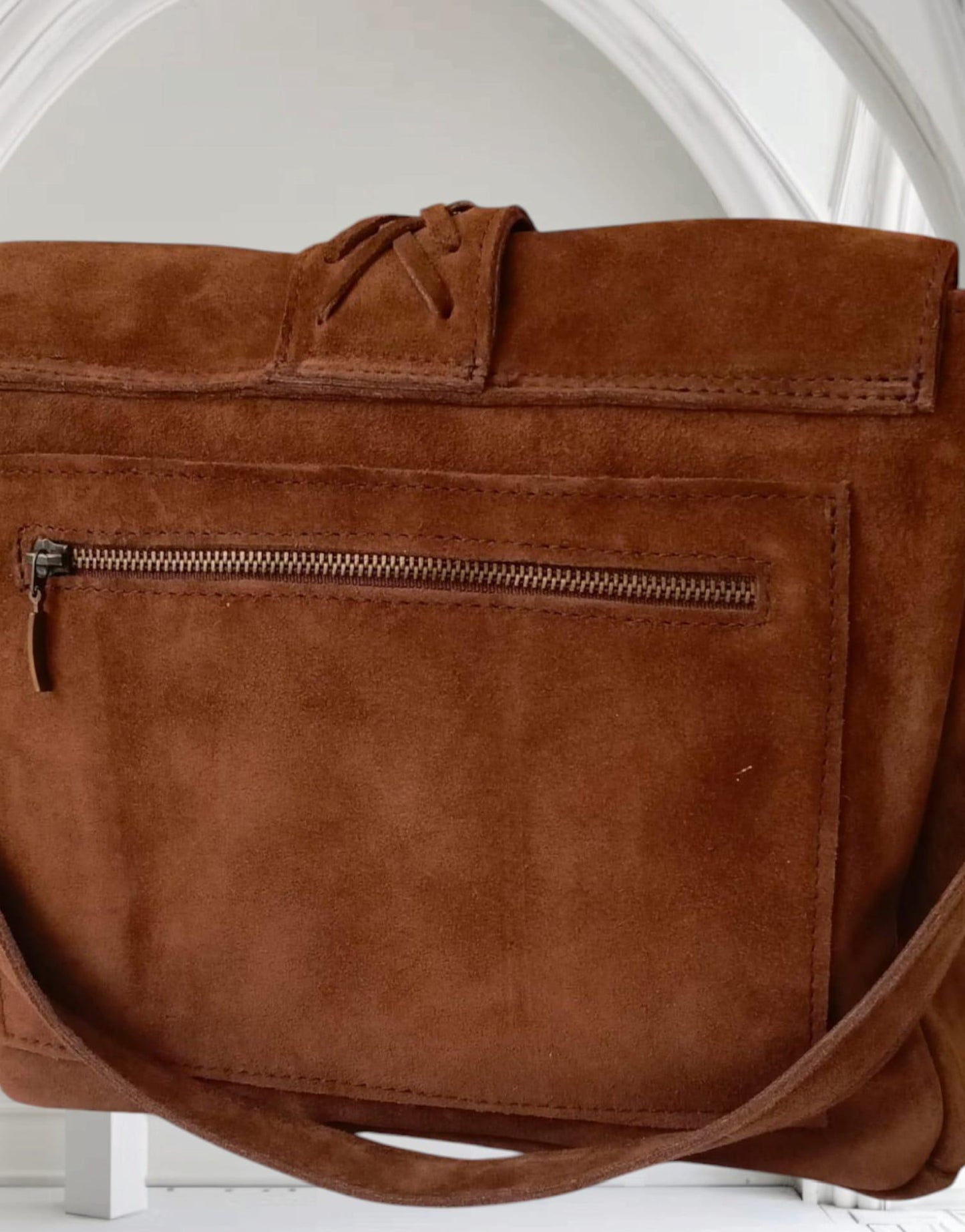 The product is a women's bag made of real suede leather.
