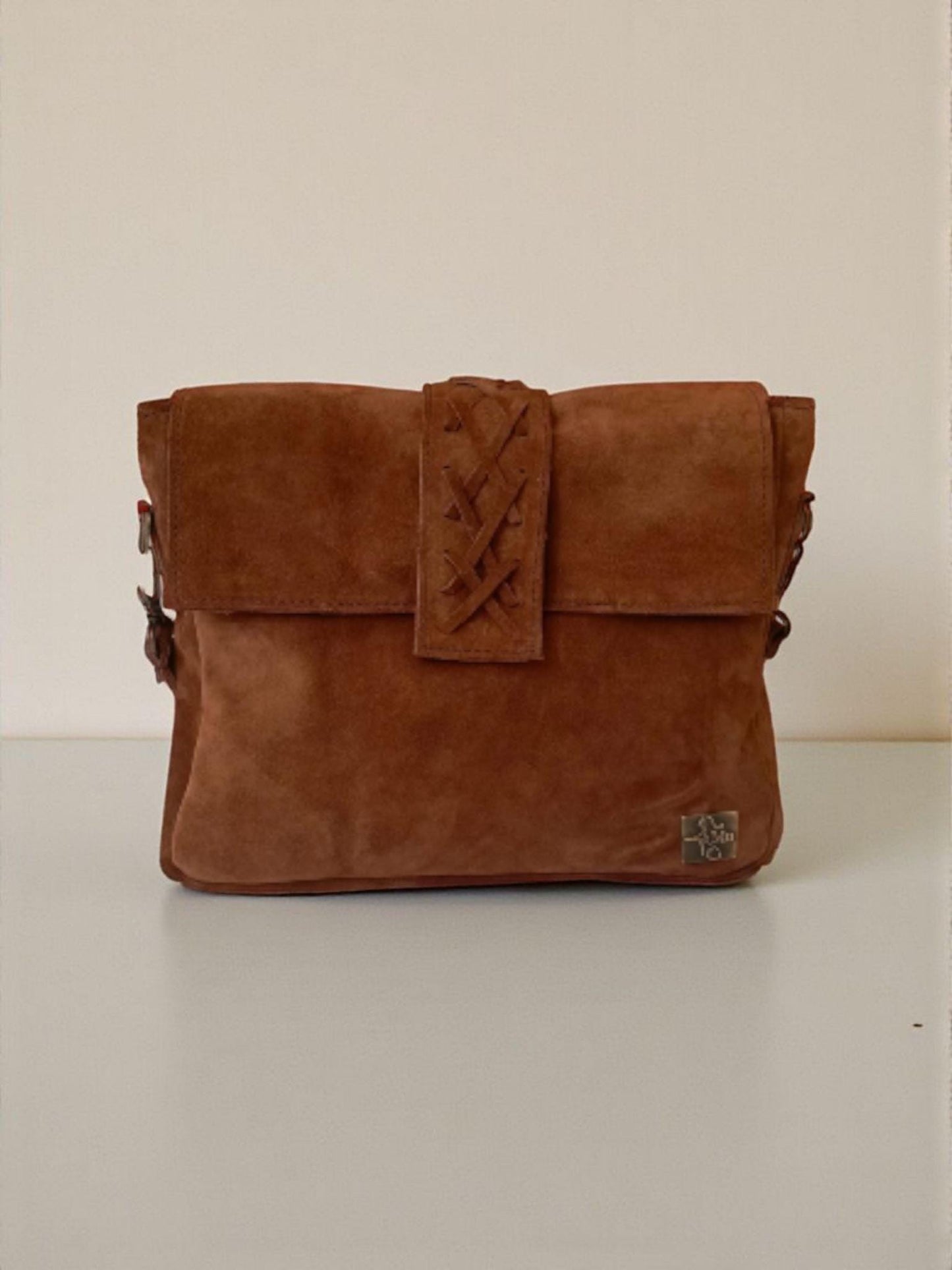 The product is a women's bag made of real suede leather.