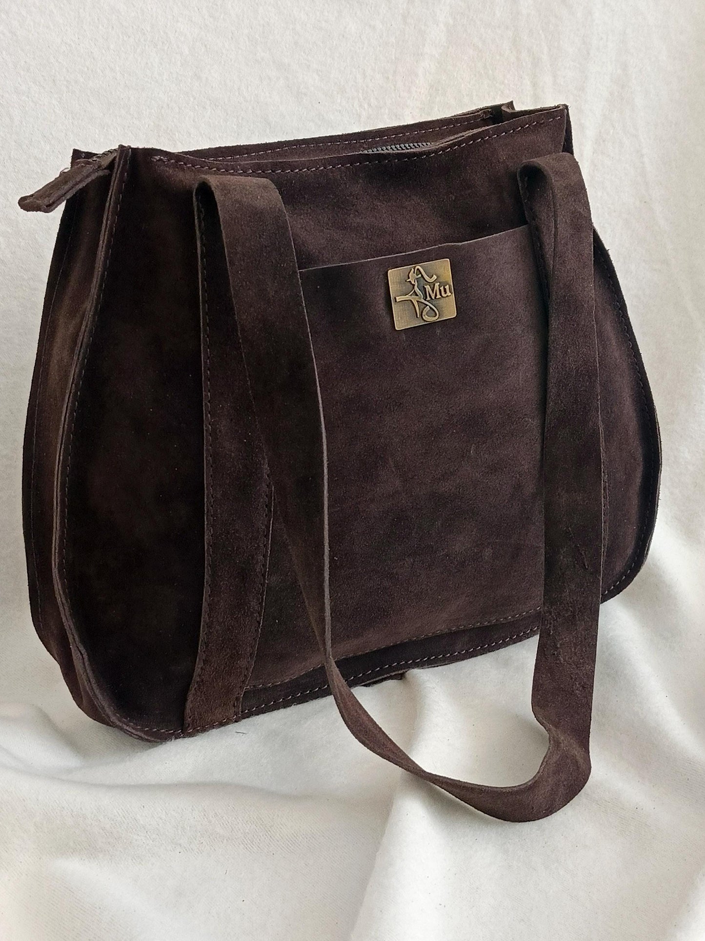 the product is made of genuine suede leather.design is a bag.suitable for daily use.